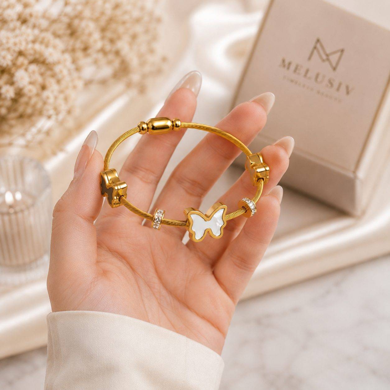 gold-plated twisted cable design accented by a white enamel butterfly and crystals